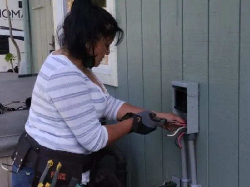 Licensed electrician wiring an exterior subpanel in Mechanic Falls